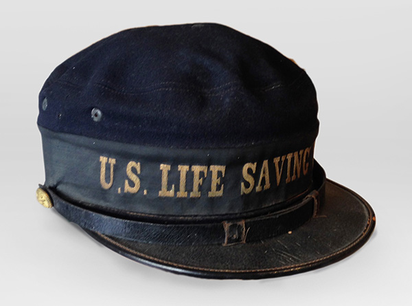 G.W. SIMMONS & CO., U.S. Life Saving Service Hat, c.1890, wool, leather, brass. Cape Ann Museum, Gloucester, MA. Gift of Peter Lawrence, 2019 [#2019.45].